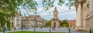 Front Square at Trinity College Dublin in Dublin, Ireland, featuring historic stone buildings, the iconic bell tower, and leafy trees surrounding the university courtyard.