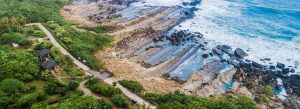 Aerial view of layered coastal rock formations and ocean waves at Fugang Geopark in Taitung, Taiwan