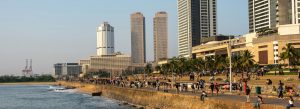 Crowds enjoying the oceanfront promenade at Galle Face Green in Colombo, Sri Lanka during sunset
