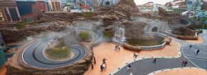 Aerial view of Genting SkyWorlds Theme Park in Malaysia featuring thrilling rides, winding tracks, rock landscapes, and entertainment zones.