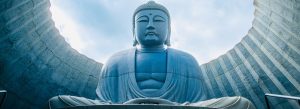 Massive Buddha statue at Hill of the Buddha shrine surrounded by modern concrete architecture in Sapporo, Hokkaido, Japan.