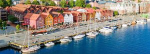 Historic Bryggen waterfront district in Bergen, Norway featuring colorful wooden buildings along the harbor and traditional Nordic architecture.