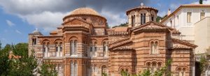 Historic Byzantine architecture of Hosios Loukas Monastery with ornate brickwork and domed roofs in Greece.