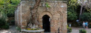 Ancient stone house believed to be the House of the Virgin Mary in Ephesus, surrounded by lush greenery in Turkey.