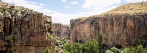 Scenic cliffs and green canyon landscape in Ihlara Valley, Cappadocia, Turkey.