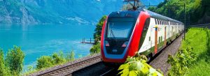 Scenic train journey from Interlaken to Lucerne passing turquoise lakes and Swiss mountain landscapes in Switzerland.