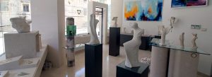 Interior view of Jakšić Gallery on Brač Island, Croatia, featuring contemporary stone sculptures and modern artwork displayed in a bright gallery space.