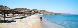 Crystal-clear waters and sun loungers at Kalafatis Beach in Mykonos, Greece