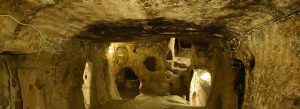 Ancient tunnels and carved stone chambers inside Kaymakli Underground City in Cappadocia, Turkey.