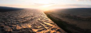 Golden Khongor Sand Dunes in Mongolia at sunset with vast desert landscape and dramatic light