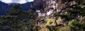 Kila Goemba monastery perched on a cliffside in Bhutan surrounded by forested mountains
