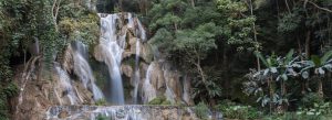 Kuang Si Falls cascading through lush tropical jungle near Luang Prabang