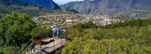 Visitors enjoying panoramic views from La Roche Merveilleuse overlooking Cilaos and the surrounding volcanic mountains.