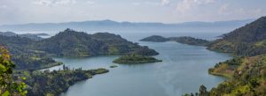 Scenic view of Lake Kivu in Rwanda with green hills, islands, and calm blue water.