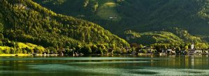Scenic view of Lake Wolfgang in Austria surrounded by green mountains forests and lakeside village homes