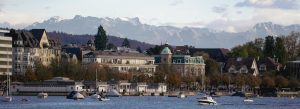 Scenic view of Lake Zurich with boats and historic buildings, Switzerland.
