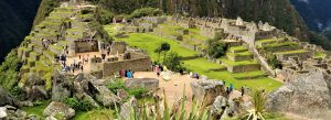 Panoramic view of Machu Picchu Inca ruins with stone terraces and mountains in Peru.