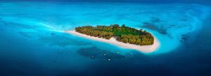 Aerial view of Mnemba Island off the coast of Zanzibar with white sandy beaches and turquoise Indian Ocean