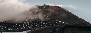 Mount Etna volcano with mist and snow patches Sicily Italy landscape