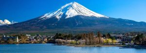 Snow-covered Mount Fuji viewed from the peaceful shores of Lake Kawaguchi in Japan.