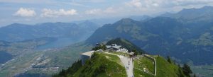 Panoramic aerial view from Mount Stanserhorn overlooking Lake Lucerne and the Swiss Alps in Switzerland.