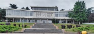 Front view of the Museum of Yugoslavia in Belgrade, Serbia, featuring modernist architecture, wide stairs, and landscaped greenery.