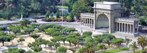 Aerial view of the Music Concourse and bandshell in Golden Gate Park, San Francisco, surrounded by lush gardens and tree-lined walkways.