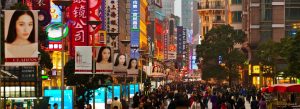 Crowded Nanjing Road shopping street with neon lights and vibrant city atmosphere