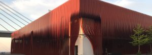 Modern exterior of Nebuta Museum Wa Rasse in Aomori, Japan with distinctive red architectural facade