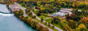 Aerial view of Niagara Parkway lined with colorful autumn trees beside the Niagara River in Ontario, Canada