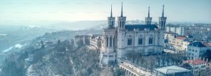 Panoramic view of Notre-Dame de Fourvière Basilica overlooking Lyon, France on a misty morning.