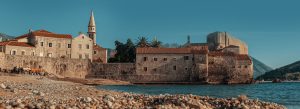 Historic stone buildings and citadel on the coastline of Budva Old Town with Adriatic Sea views in Montenegro