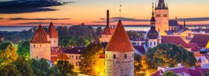 Panoramic evening view of Tallinn Old Town with medieval towers and historic churches in Estonia.