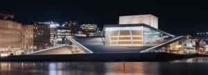 Modern Oslo Opera House illuminated at night beside the waterfront in Oslo, Norway.