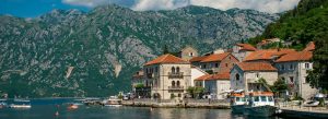 Traditional seaside village with mountains and boats in Perast along the Bay of Kotor