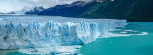 Perito Moreno Glacier in Los Glaciares National Park, Argentina, featuring towering blue ice walls surrounded by mountains and turquoise water.