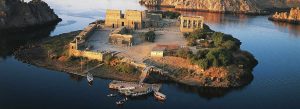 Aerial view of Philae Temple complex on Agilkia Island surrounded by the Nile River near Aswan, Egypt.