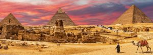 The Great Pyramids of Giza and the Sphinx in Egypt during a colorful sunset desert panorama