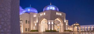 Qasr Al Watan Abu Dhabi with glowing domes and grand arches illuminated at night