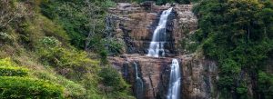 Scenic view of Ramboda Falls cascading through lush green hills in Sri Lanka’s central highlands.