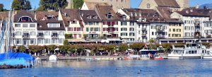 Historic lakeside buildings and marina in Rapperswil, Switzerland with boats along Lake Zurich waterfront