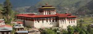 Rinpung Dzong fortress monastery overlooking the Paro Valley in Bhutan with traditional Bhutanese architecture and scenic mountain landscape.