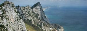 Panoramic view of the Rock of Gibraltar overlooking the Mediterranean Sea and dramatic limestone cliffs.