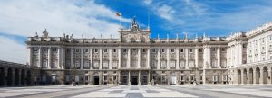 Royal Palace of Madrid in Spain with grand neoclassical architecture and open courtyard under a blue sky