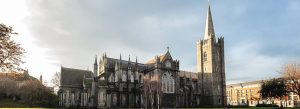 Saint Patrick’s Cathedral in Dublin with Gothic architecture and tall stone spire under a bright Irish sky.