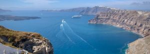 Panoramic view of the Santorini caldera with volcanic cliffs and deep blue waters in Greece