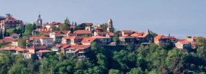Panoramic view of Sighnaghi with red-roofed houses, historic churches, and scenic hillside landscapes in Georgia’s Kakheti wine region.