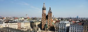 Aerial view of St. Mary's Basilica in Krakow, Poland, surrounded by the historic Old Town skyline.