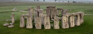Ancient stone circle at Stonehenge in Wiltshire, England under a dramatic sky.