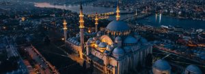 Aerial evening view of Süleymaniye Mosque illuminated over Istanbul skyline and the Golden Horn in Turkey.